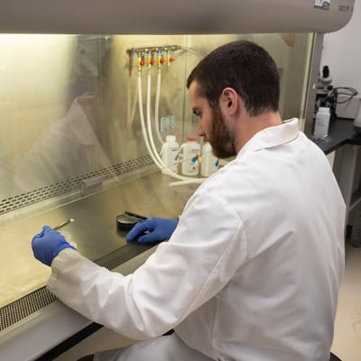 Scientist at hood talc web