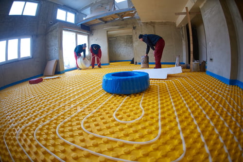 grouo of workera installing underfloor heating and colling in modern home grouo of workera installing underfloor heating and colling in modern home