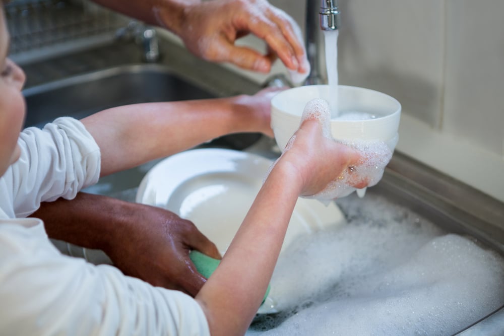 filling a bowl with water in a kitchen sink